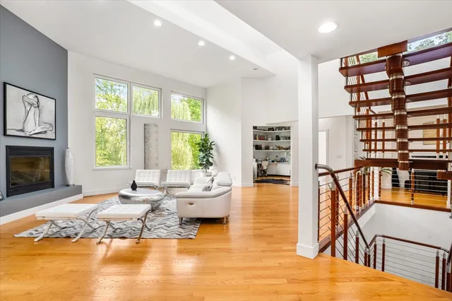 a living room with fireplace furniture and a wooden floor