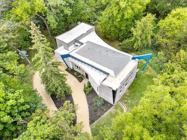 an aerial view of a house with a yard