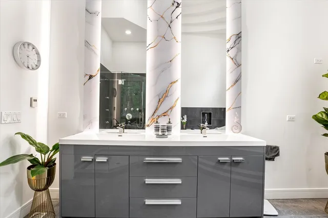 a bathroom with a sink vanity and a mirror