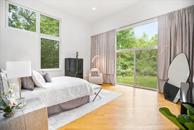 a bedroom with a bed and large window