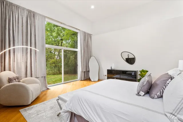 a bedroom with a large bed and a large window