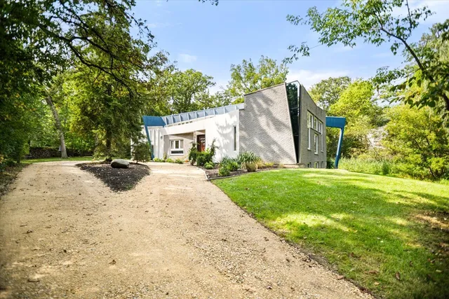 a view of a house with backyard and sitting area