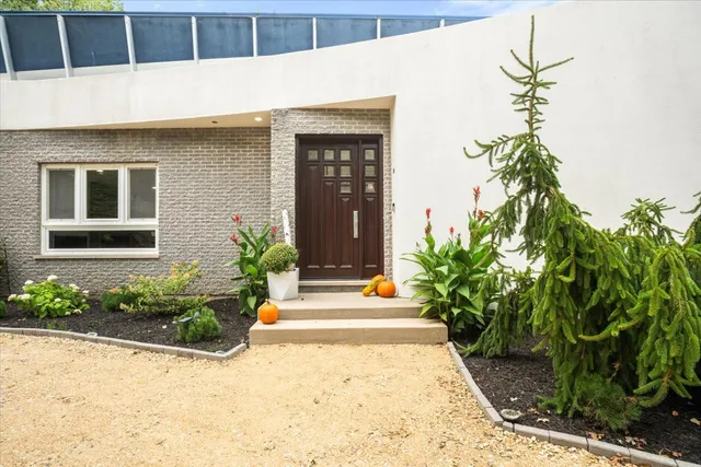 a house with potted plants in front of door