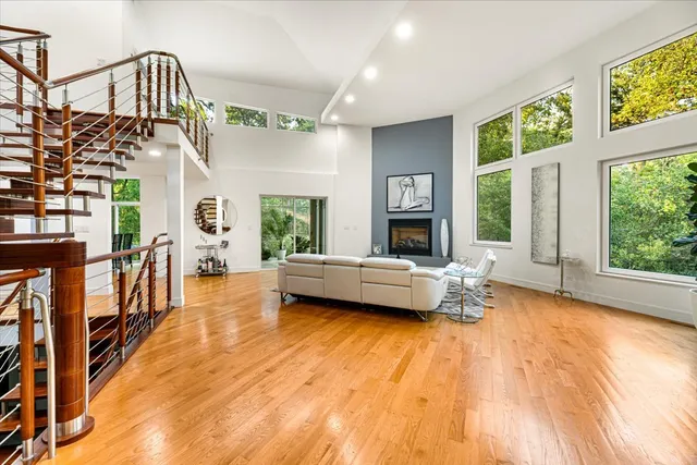 a bedroom with furniture and a large window