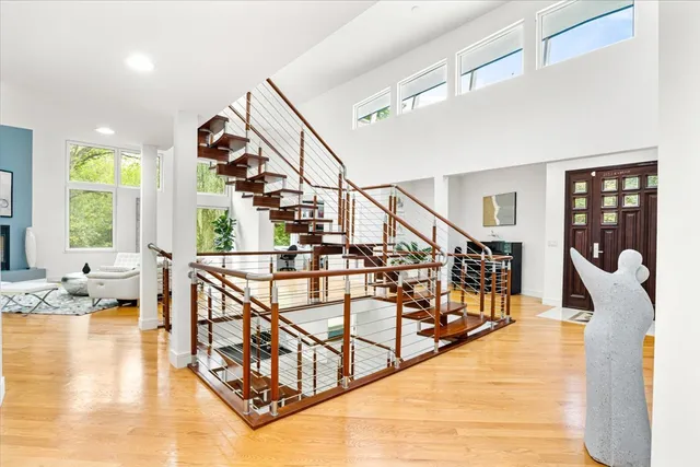 a view of entryway and hall with wooden floor