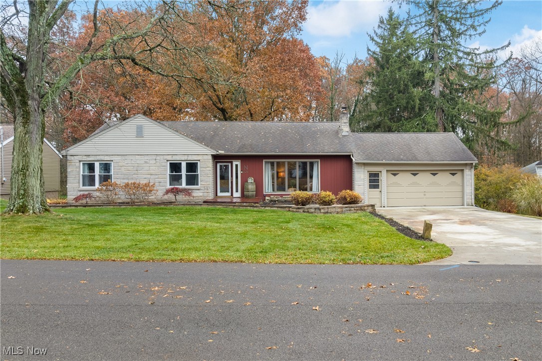 234 Reed Road Wooster, OH 44691 - Photo 1 of 36 Single story home with concrete driveway, a chimney, a front lawn, a garage, and stone siding