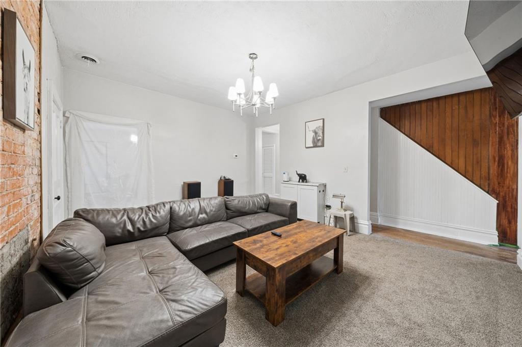 1523 Evergreen Road Pittsburgh, PA 15209 - Photo 23 of 35 a living room with furniture and a chandelier