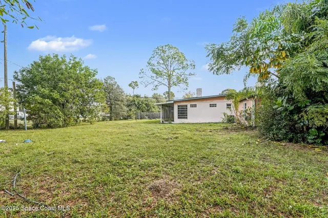 a view of outdoor space with deck and yard