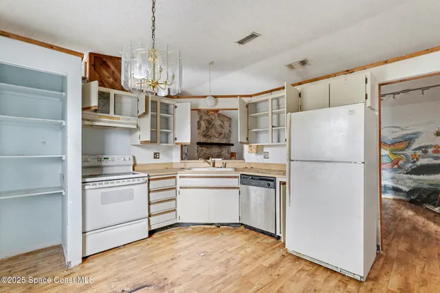 a kitchen with stainless steel appliances a refrigerator sink and cabinets