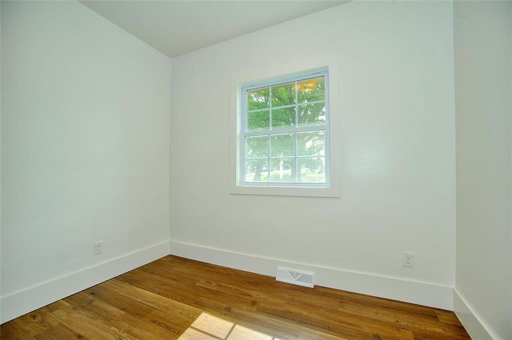 113 3rd Street Houston, PA 15342 - Photo 22 of 27 an empty room with wooden floor and windows