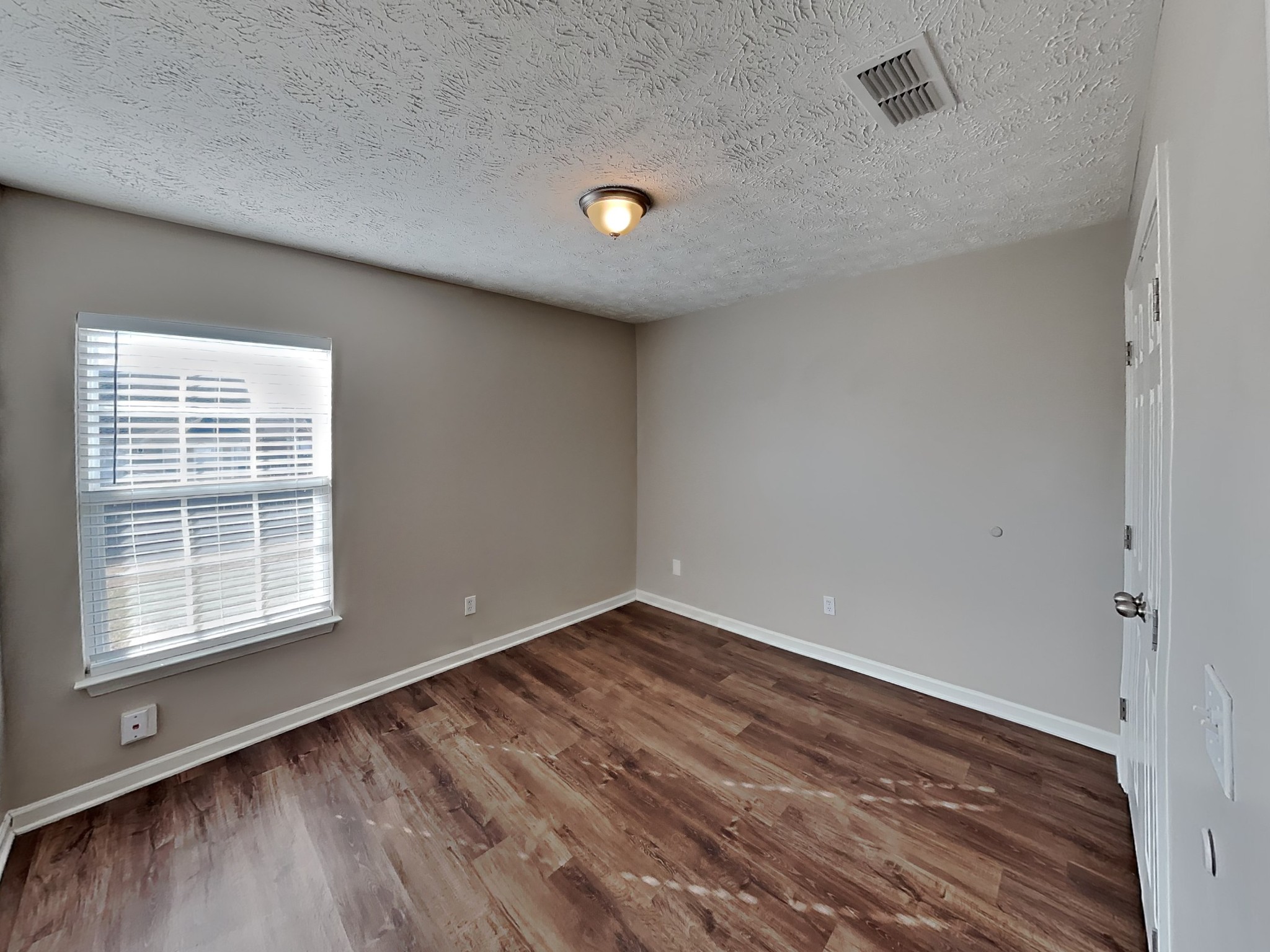 4049 Sequoia Trail Spring Hill, TN 37174 - Photo 12 of 15 an empty room with wooden floor and windows