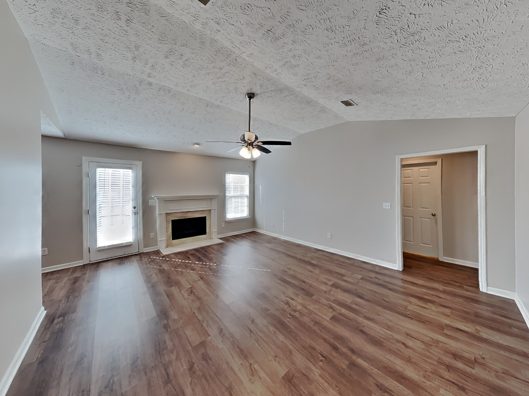 4049 Sequoia Trail Spring Hill, TN 37174 - Photo 3 of 15 an empty room with wooden floor fireplace and windows