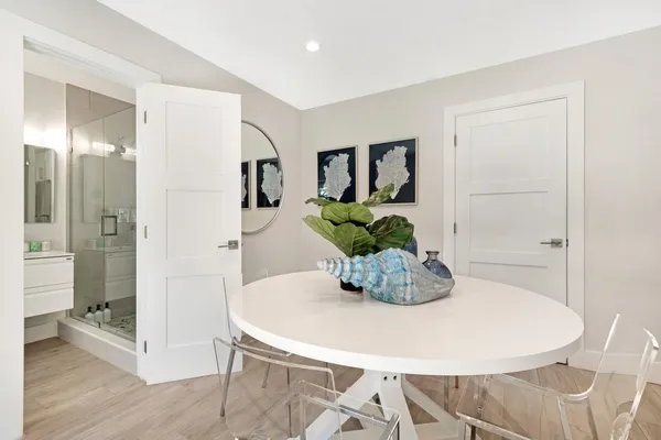 a dining room with furniture and wooden floor