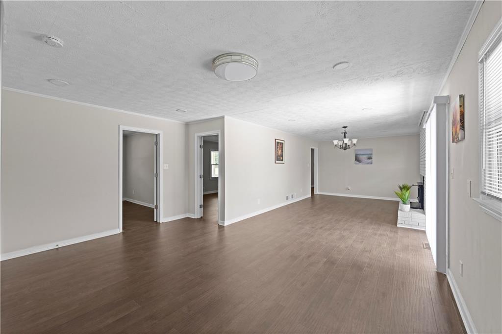 5245 Stonewall Tell Road Atlanta, GA 30349 - Photo 7 of 15 a view of empty room with wooden floor