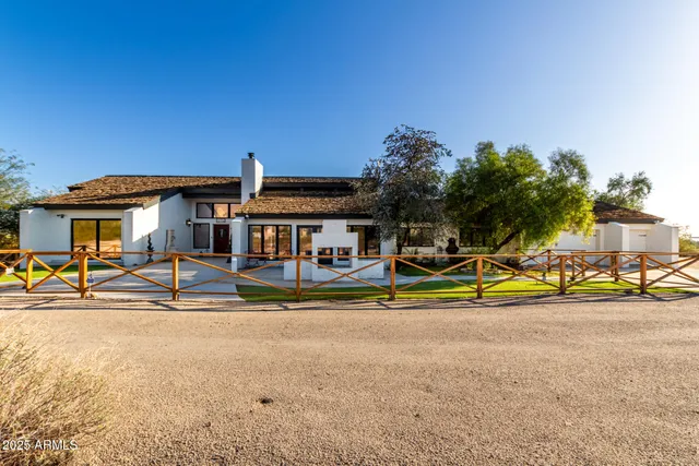 a view of pool with lawn chairs and large trees
