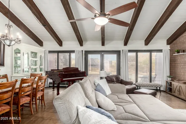 a living room with furniture ceiling fan and a rug