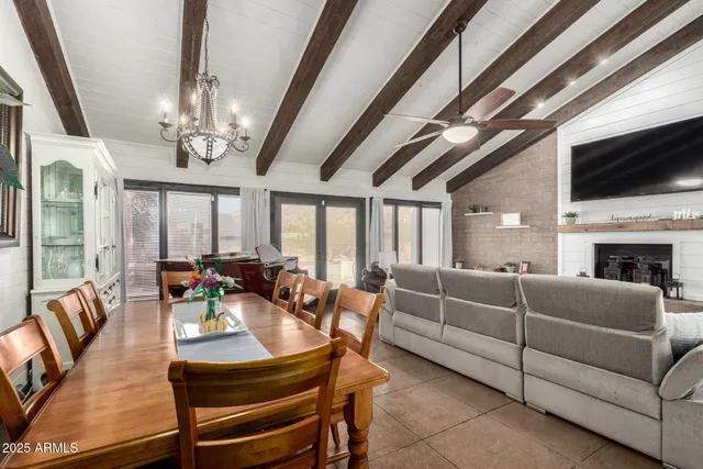 a living room with furniture a flat screen tv and a large window