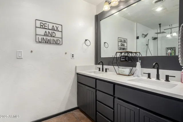 a bathroom with a sink vanity and a mirror