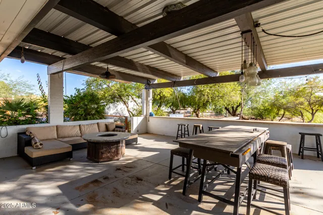 a view of a patio with iron fence