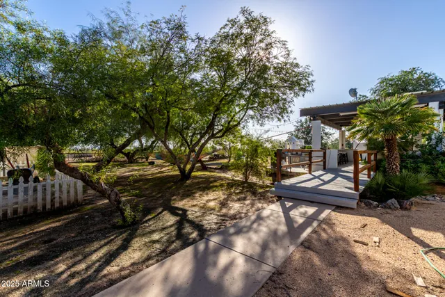 a view of a chairs and table in the backyard