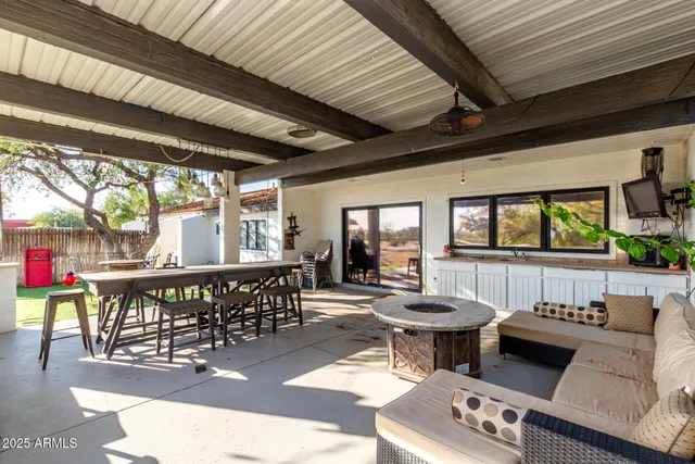 a living room with furniture and kitchen view