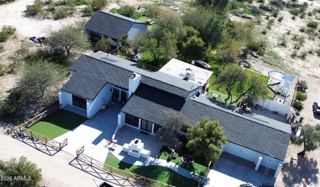 an aerial view of a house with a yard and garden