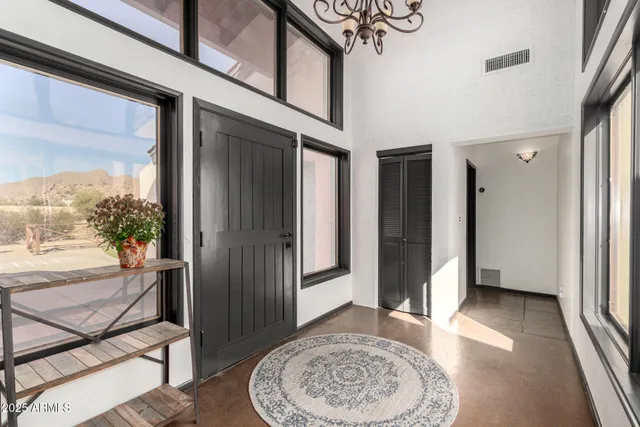 a view of an entryway with wooden floor and a rug