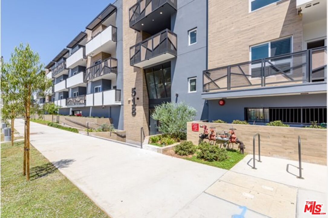 518 North Gramercy Place, Unit PH1 Los Angeles, CA 90004 - Photo 1 of 13 a front view of a building with a garden