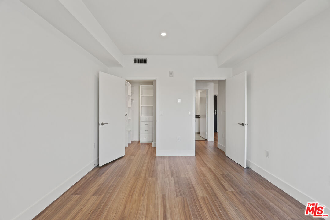 518 North Gramercy Place, Unit PH1 Los Angeles, CA 90004 - Photo 11 of 13 a big room with wooden floor and natural light