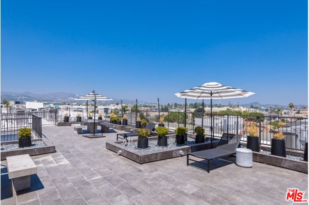 518 North Gramercy Place, Unit PH1 Los Angeles, CA 90004 - Photo 4 of 13 a living room with furniture and a table
