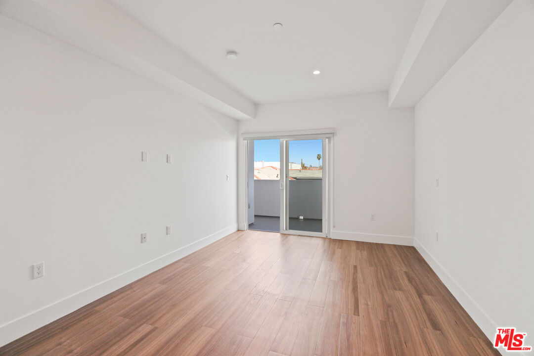 518 North Gramercy Place, Unit PH1 Los Angeles, CA 90004 - Photo 8 of 13 a view of wooden floor and windows in a room