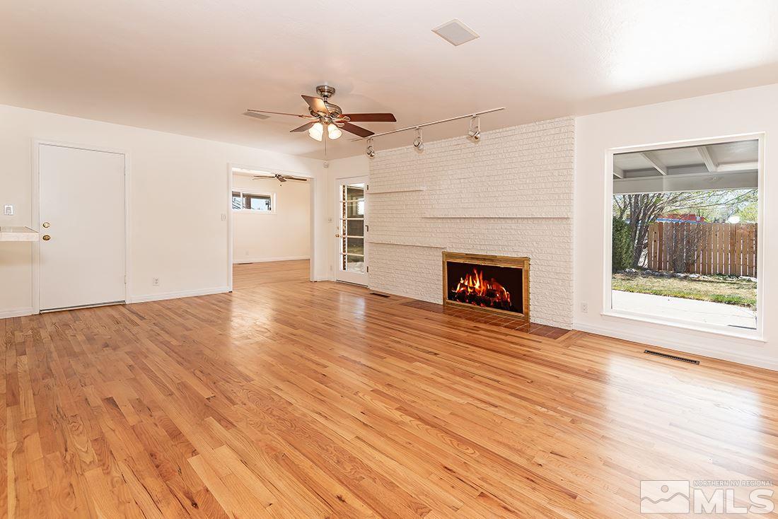 960 Robin Street Reno, NV 89509 - Photo 3 of 10 a view of empty room with wooden floor and fireplace