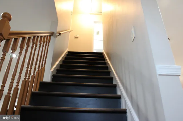 a view of an empty room with wooden floor & closet