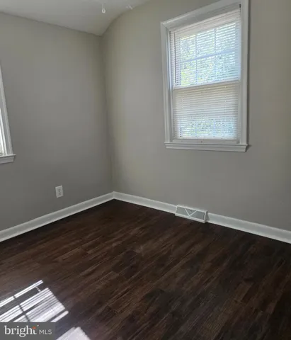 a view of a house with backyard and a sitting area