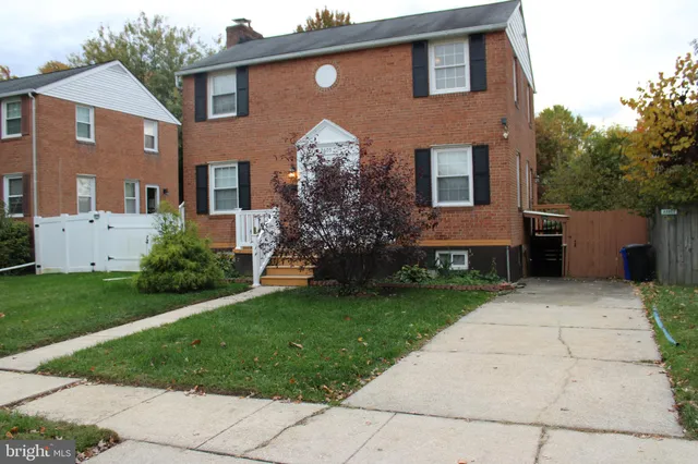 an empty room with wooden floor and white walls