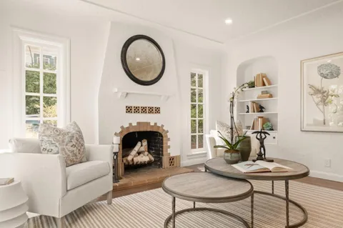 a living room with furniture a window and a fireplace