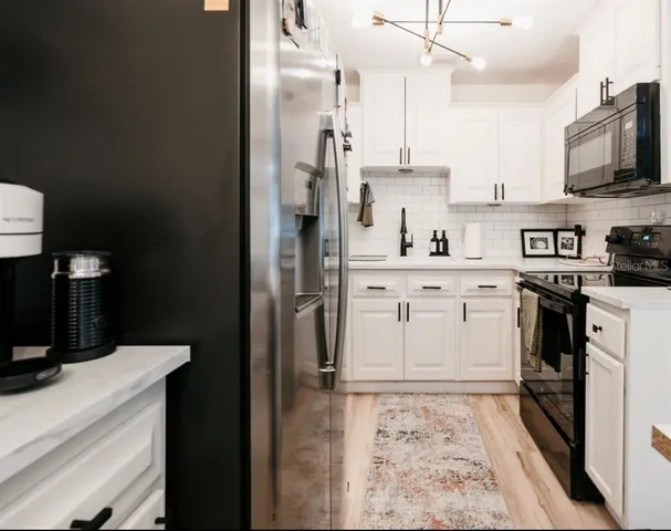 a kitchen with a sink stove and refrigerator