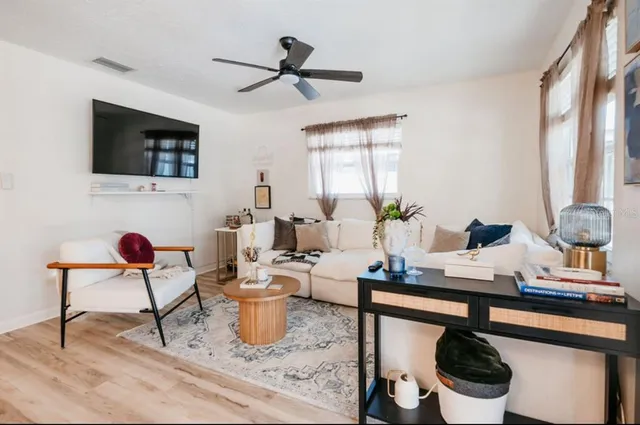 a living room with furniture and flat screen tv