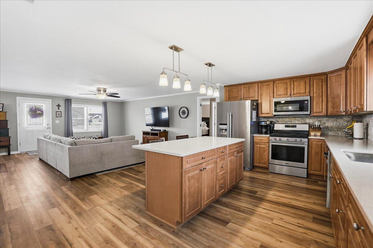 18311 Clark Street Lowell, IN 46356 - Photo 12 of 36 a large kitchen with stainless steel appliances granite countertop a stove oven and a refrigerator