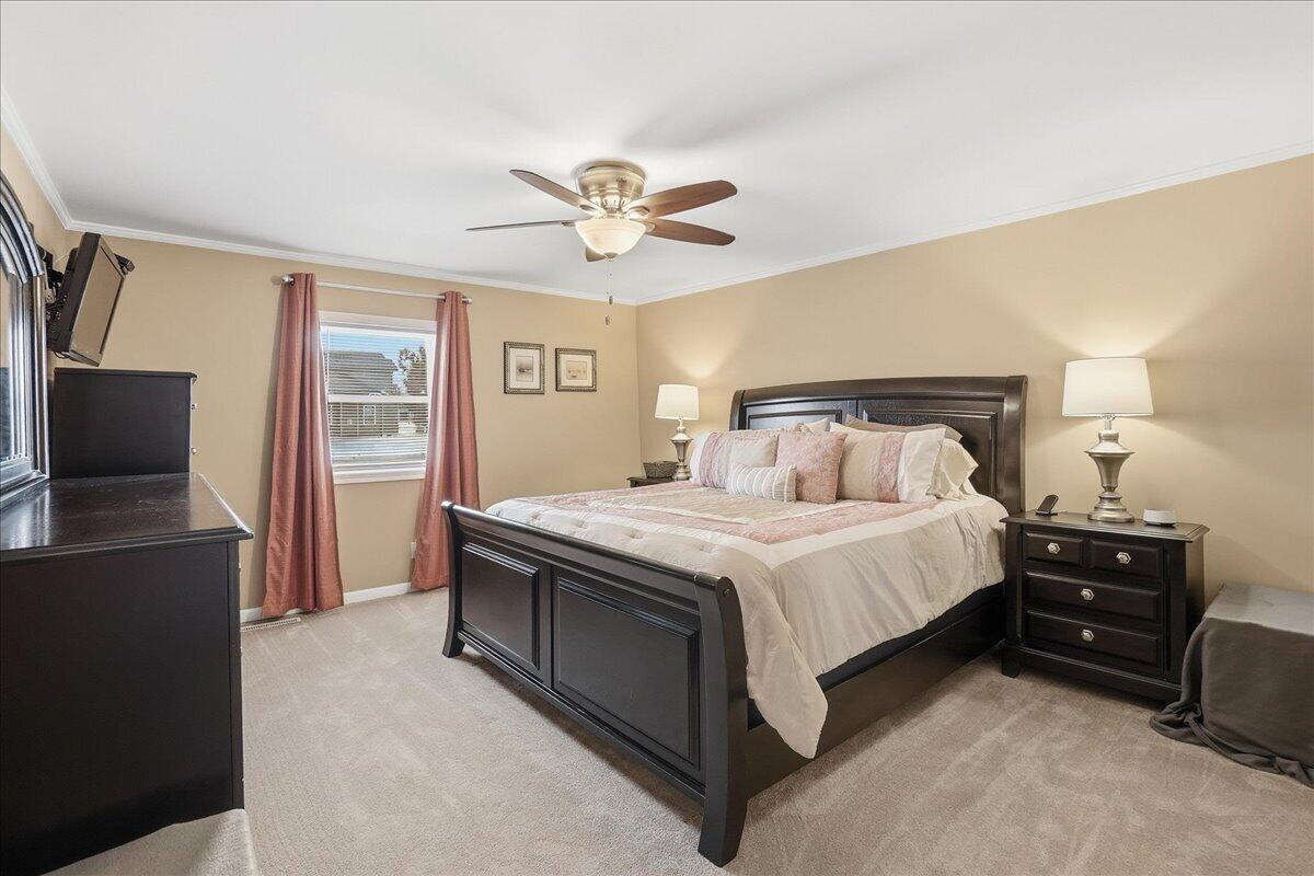 18311 Clark Street Lowell, IN 46356 - Photo 15 of 36 a bedroom with a bed and a flat screen tv