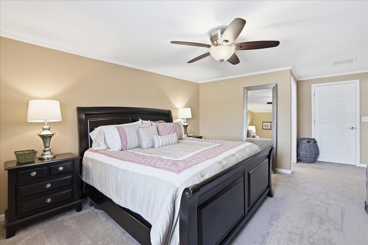 18311 Clark Street Lowell, IN 46356 - Photo 16 of 36 a bedroom with a bed and a chandelier