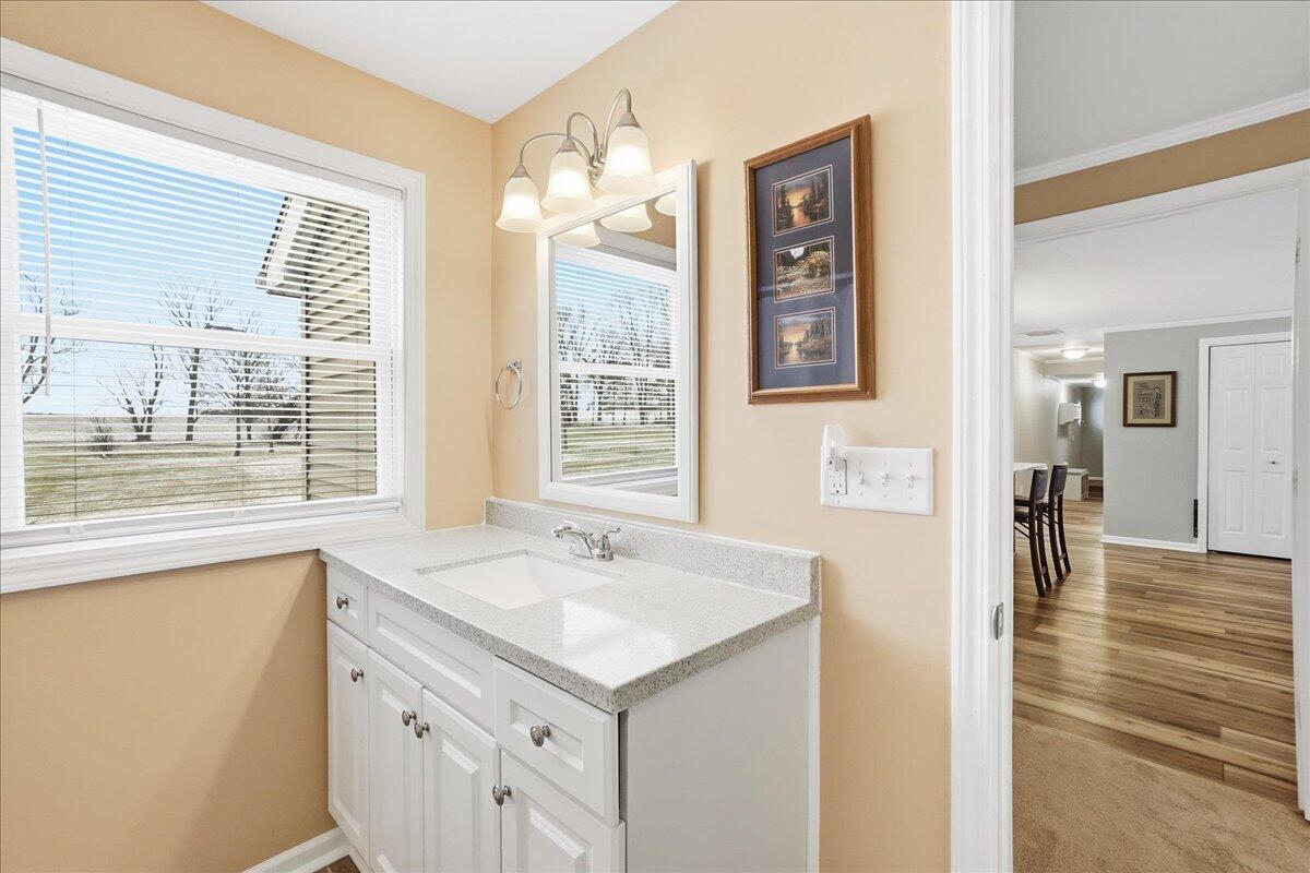 18311 Clark Street Lowell, IN 46356 - Photo 17 of 36 a bathroom with a sink and a large mirror next to a window