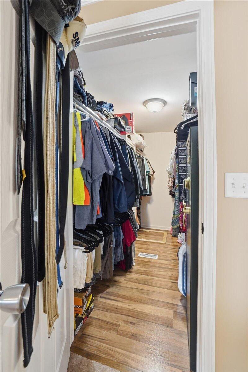 18311 Clark Street Lowell, IN 46356 - Photo 19 of 36 a view of walk in closet with clothes and shoes