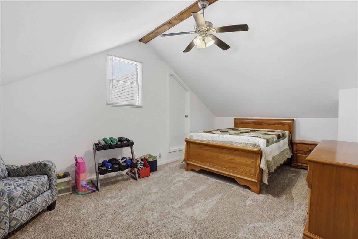 18311 Clark Street Lowell, IN 46356 - Photo 24 of 36 a bedroom with bed and a chandelier
