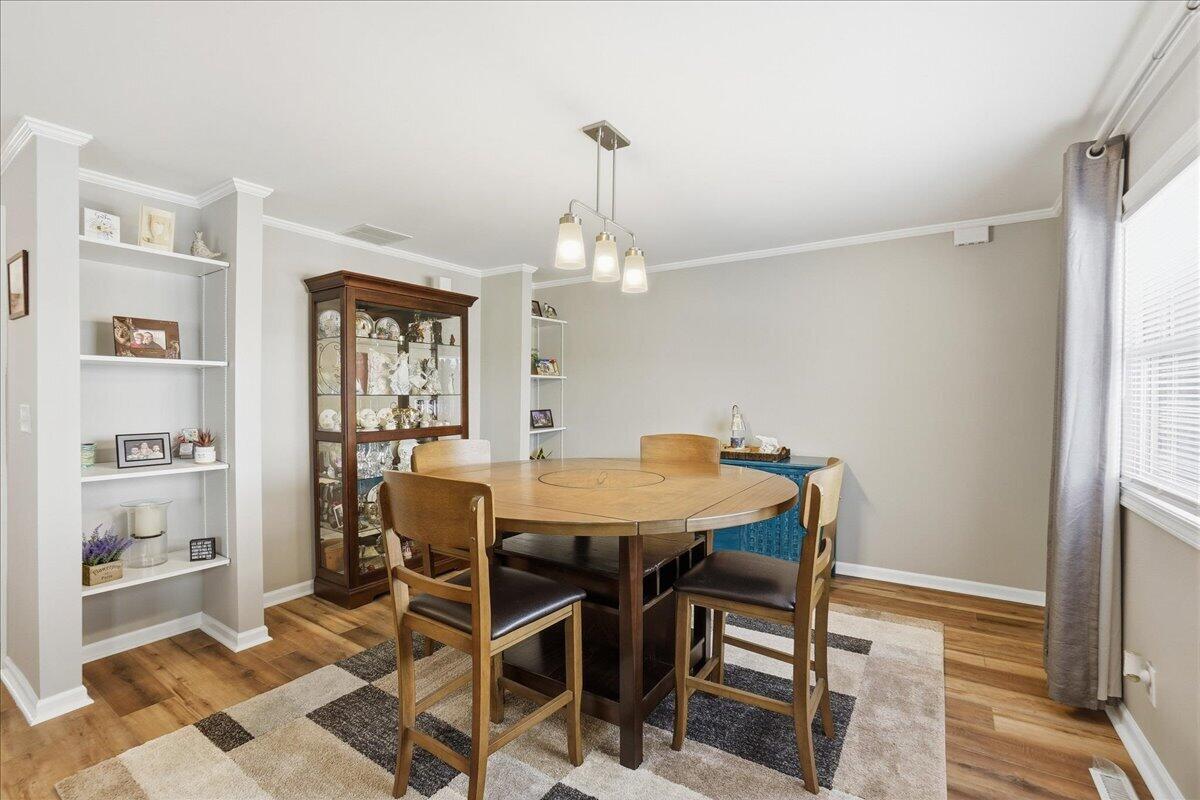 18311 Clark Street Lowell, IN 46356 - Photo 5 of 36 a view of a dining room with furniture and wooden floor