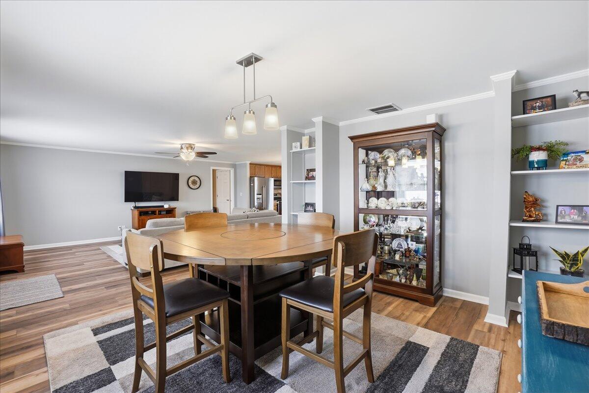 18311 Clark Street Lowell, IN 46356 - Photo 7 of 36 a view of a dining room with furniture and wooden floor