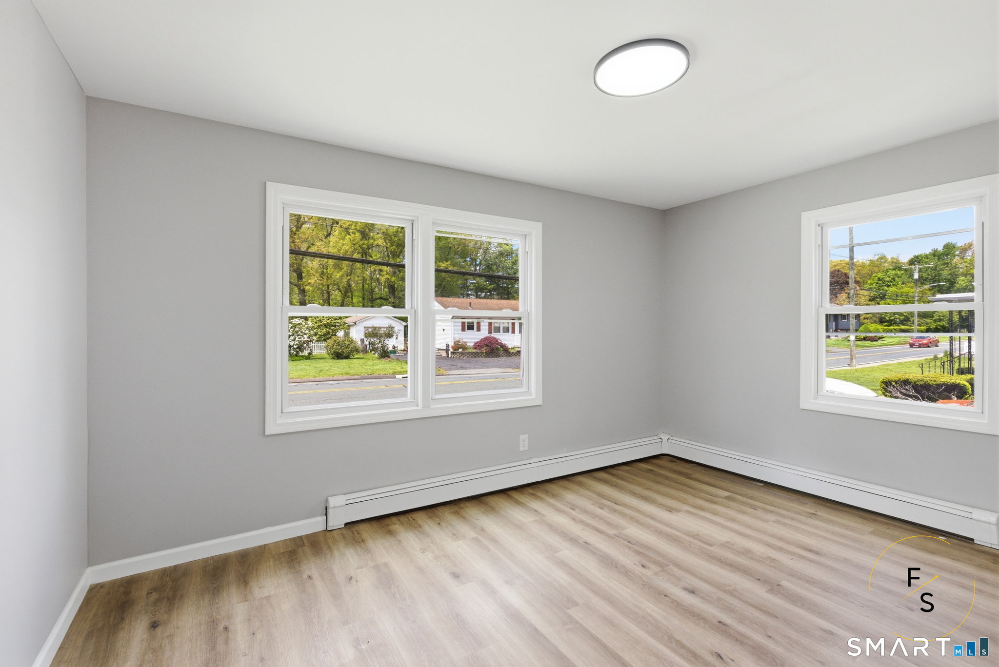 65 Broad Street Manchester, CT 06042 - Photo 14 of 40 an empty room with wooden floor and windows