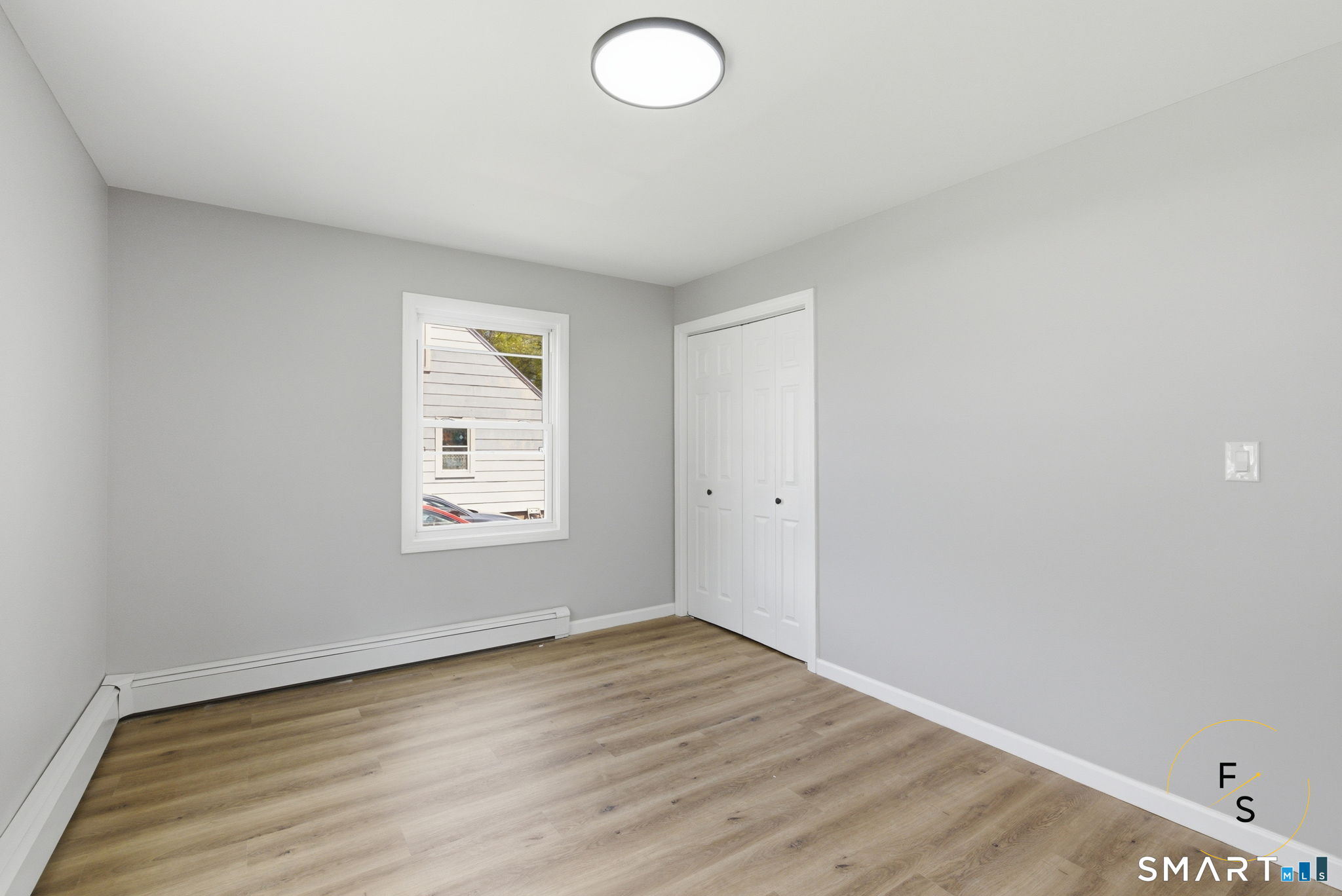 65 Broad Street Manchester, CT 06042 - Photo 15 of 40 an empty room with wooden floor and windows