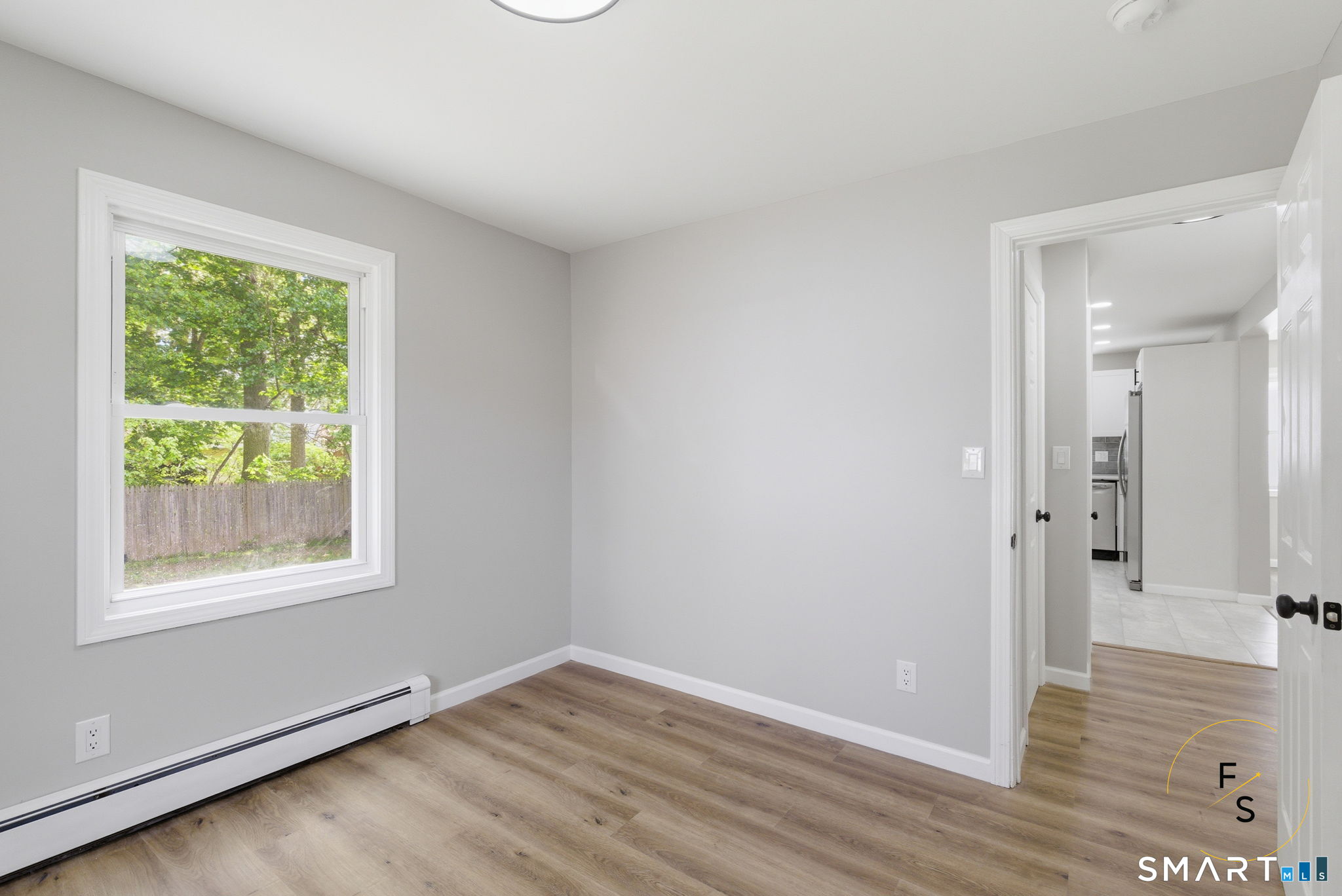 65 Broad Street Manchester, CT 06042 - Photo 17 of 40 a view of an empty room with wooden floor and a window