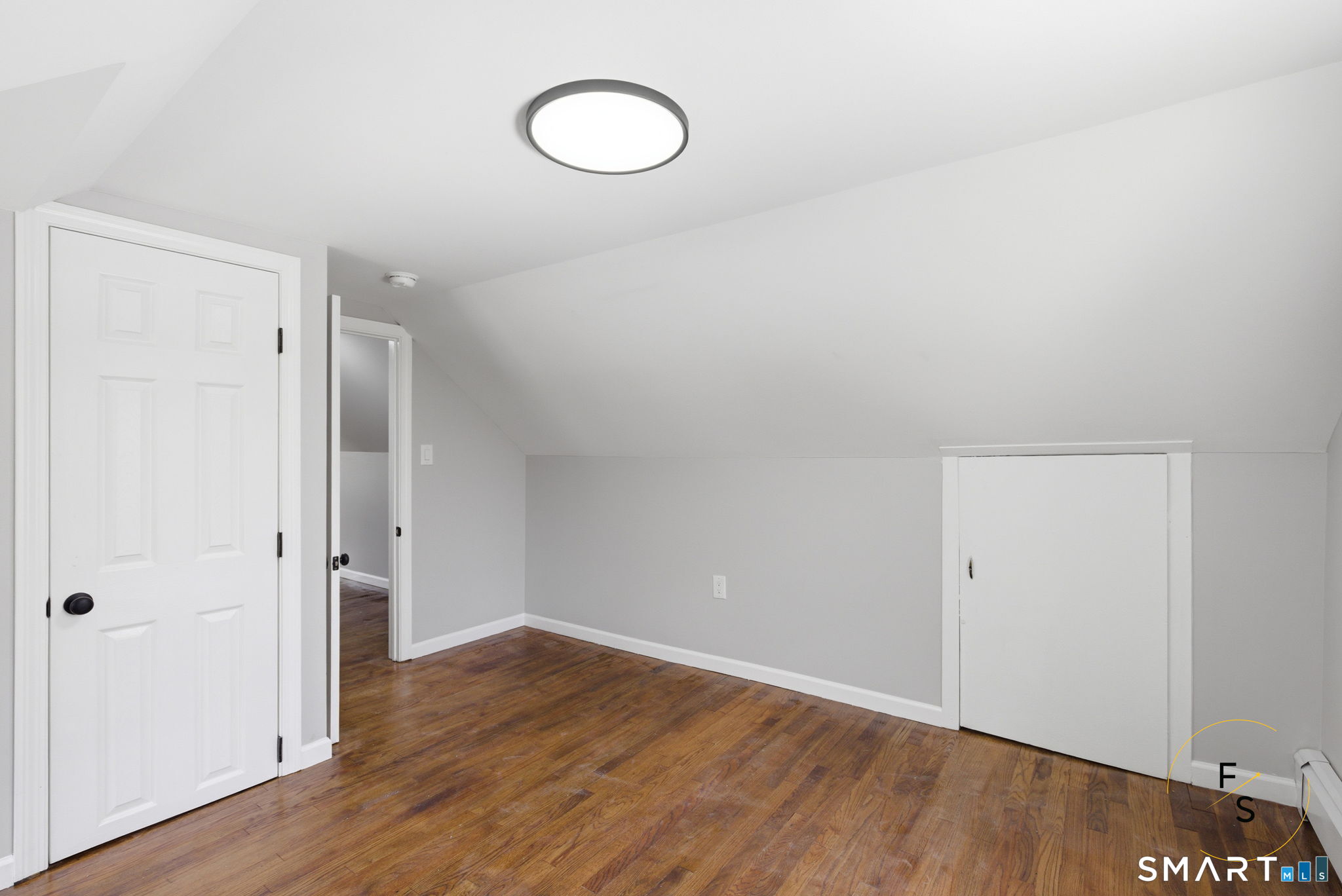 65 Broad Street Manchester, CT 06042 - Photo 22 of 40 a view of an empty room with wooden floor